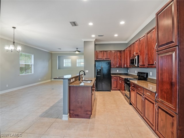 kitchen with pendant lighting, crown molding, sink, and black appliances