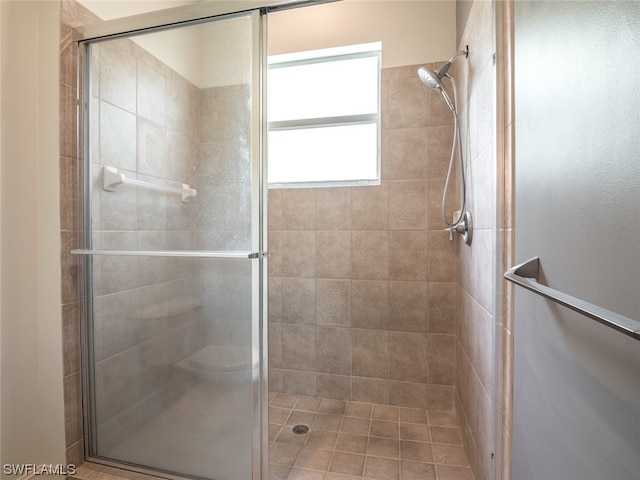 bathroom featuring a shower with door