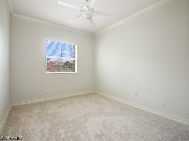 carpeted empty room with crown molding and ceiling fan