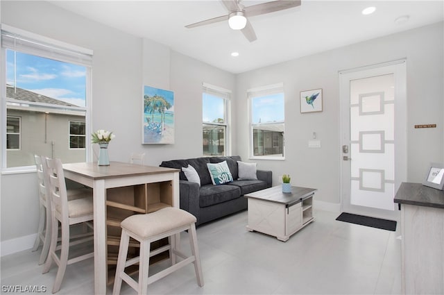 living room featuring ceiling fan and light tile floors