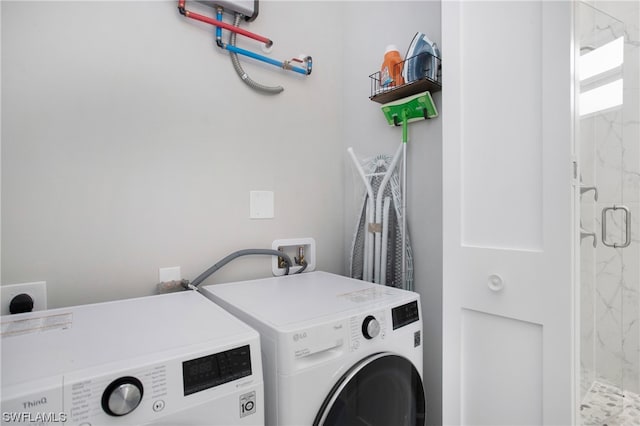 laundry room with hookup for a washing machine, hookup for an electric dryer, and separate washer and dryer