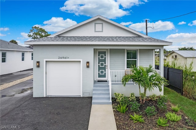 bungalow with a porch and a garage