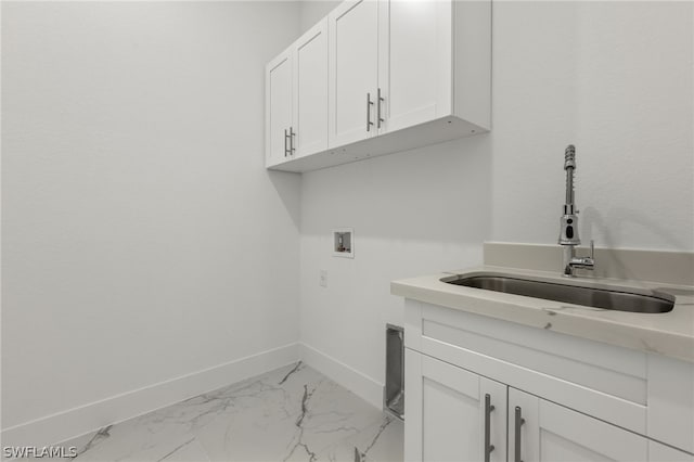 laundry room featuring hookup for a washing machine, cabinets, sink, and light tile flooring