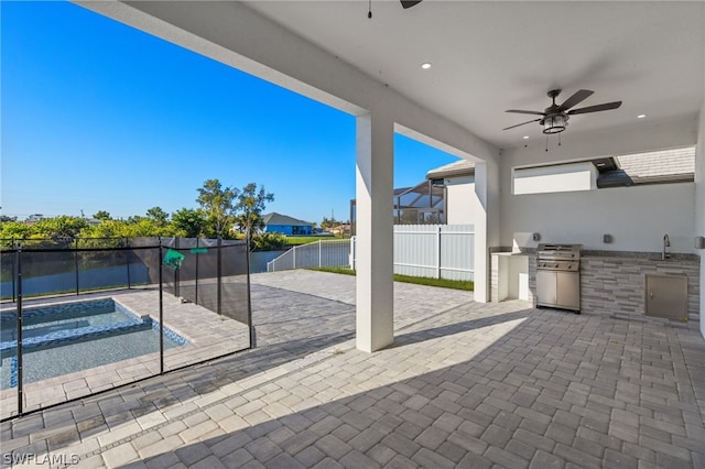 view of patio featuring ceiling fan, area for grilling, and a fenced in pool