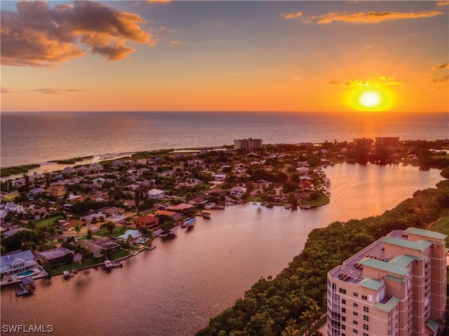 aerial view at dusk with a water view