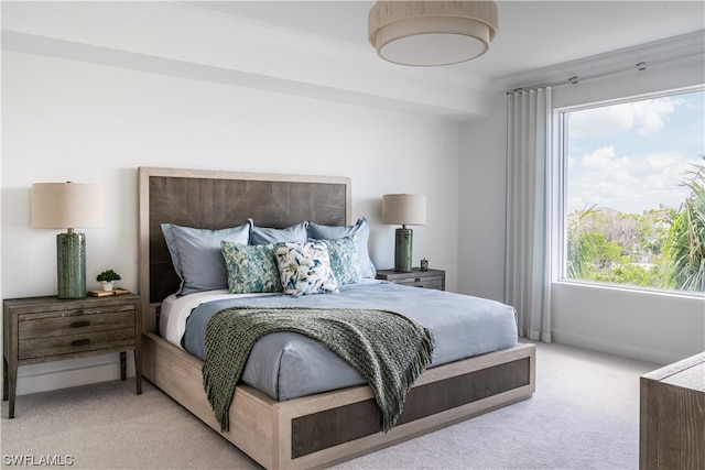 carpeted bedroom featuring multiple windows and crown molding