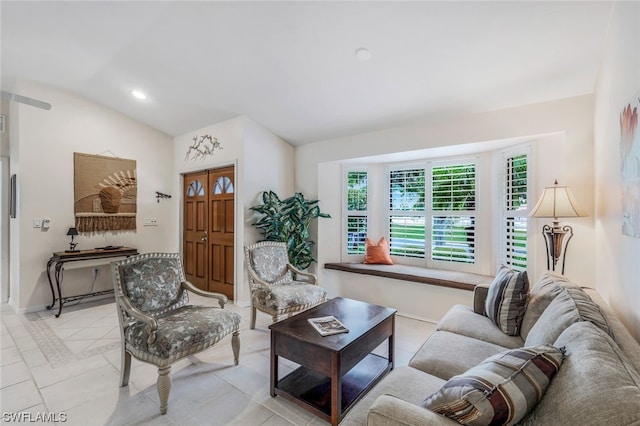 living room featuring light tile patterned floors and lofted ceiling