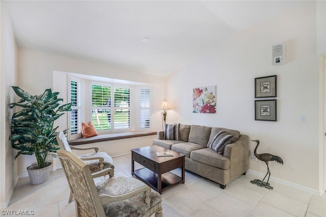 living room with lofted ceiling and light tile patterned flooring