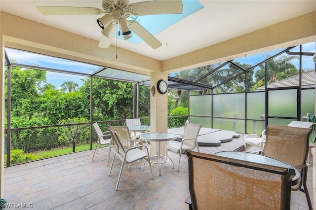 sunroom / solarium featuring ceiling fan