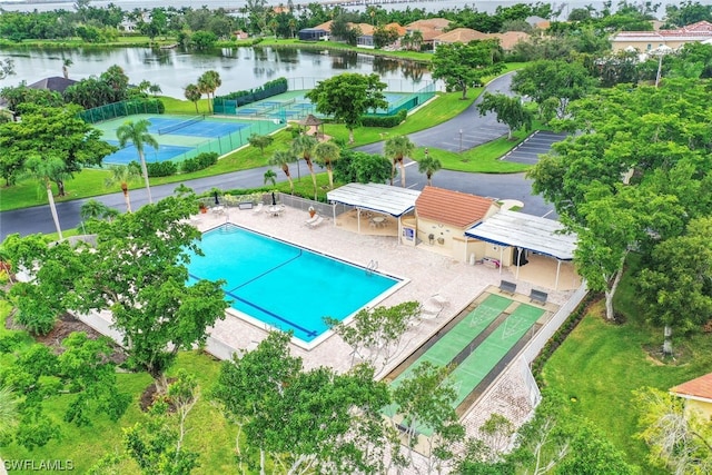 view of swimming pool with a patio and a water view