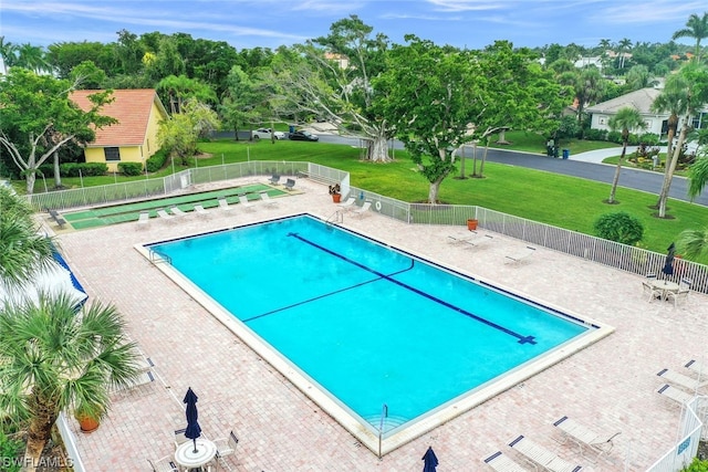 view of pool with a yard