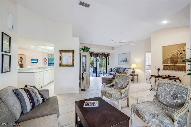 living room with ceiling fan, light tile patterned floors, and lofted ceiling