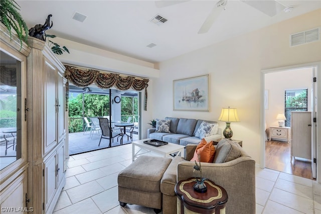 living room featuring ceiling fan and light hardwood / wood-style flooring