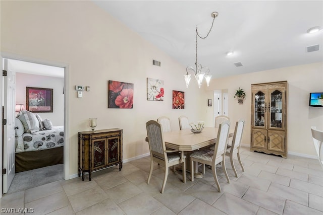 tiled dining room with a notable chandelier and vaulted ceiling