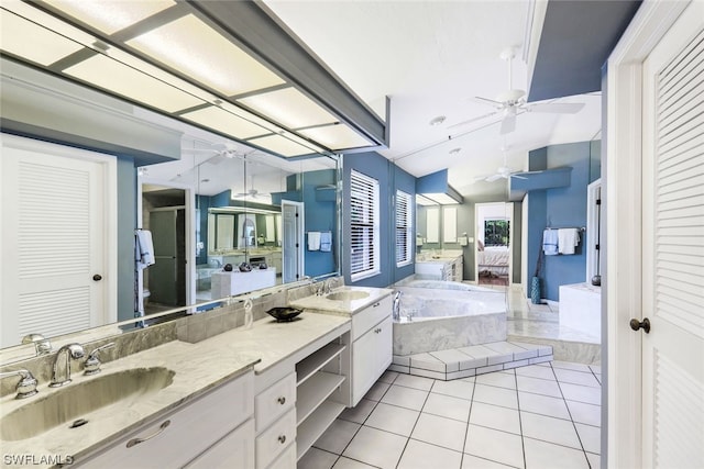 bathroom featuring vanity, lofted ceiling, tile patterned floors, ceiling fan, and tiled bath