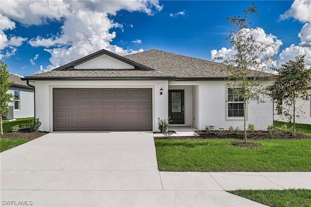 view of front of home with a front yard and a garage