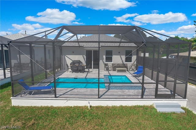 view of pool with a patio area, an in ground hot tub, and a lanai