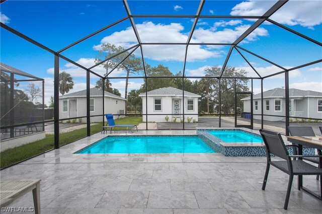 view of pool featuring an outdoor structure, a patio area, an in ground hot tub, and a lanai