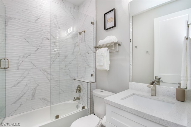 full bathroom with toilet, combined bath / shower with glass door, and vanity