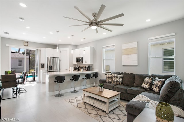 tiled living room featuring ceiling fan