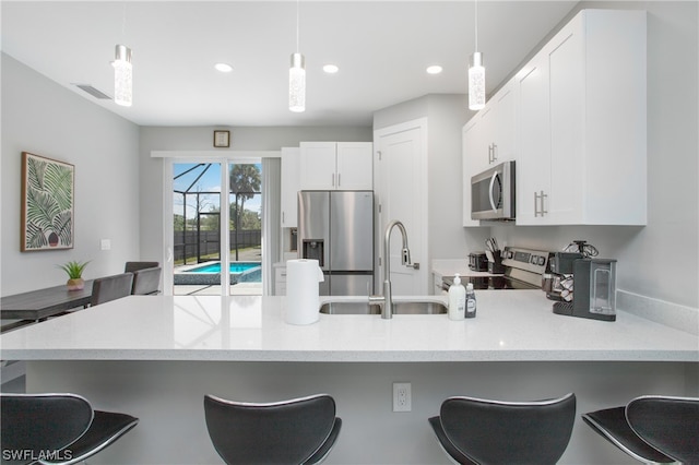 kitchen featuring pendant lighting, a breakfast bar area, and stainless steel appliances