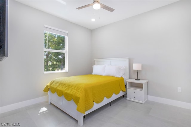 tiled bedroom featuring ceiling fan