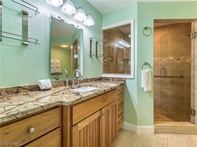 bathroom featuring vanity, tile flooring, and a shower with door