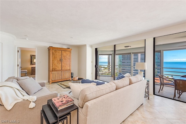 living room with plenty of natural light, crown molding, light tile floors, and a water view