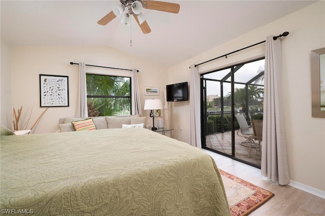 bedroom featuring access to exterior, lofted ceiling, multiple windows, and light wood-type flooring