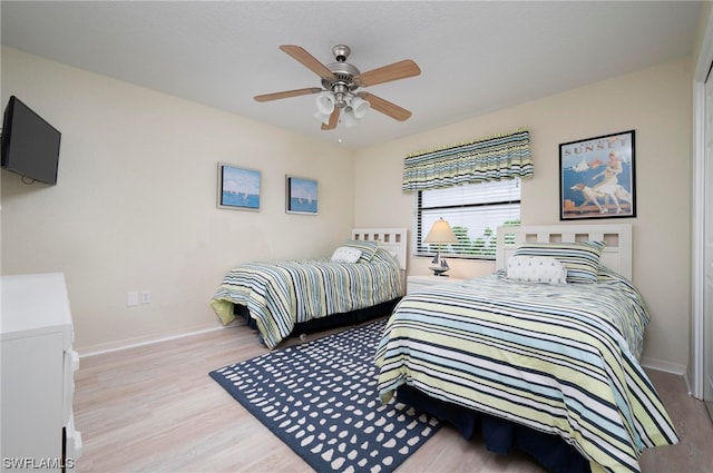 bedroom with ceiling fan and light wood-type flooring