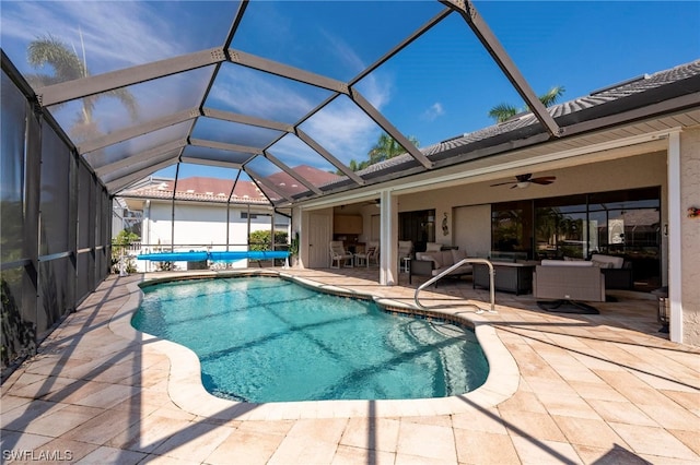 view of pool featuring a lanai, ceiling fan, a patio area, and an outdoor hangout area