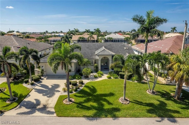 mediterranean / spanish home featuring a front lawn