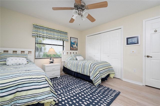 bedroom with ceiling fan, light hardwood / wood-style floors, and a closet