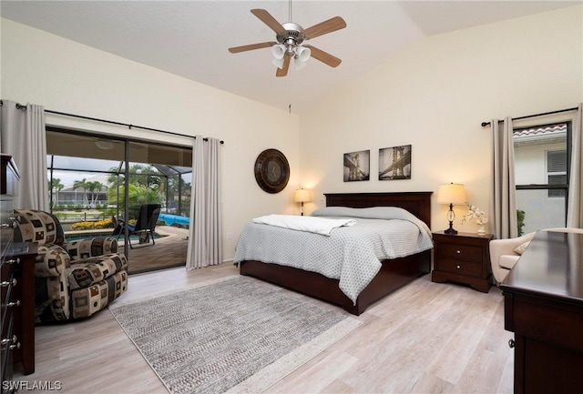 bedroom featuring access to outside, ceiling fan, light hardwood / wood-style floors, and vaulted ceiling