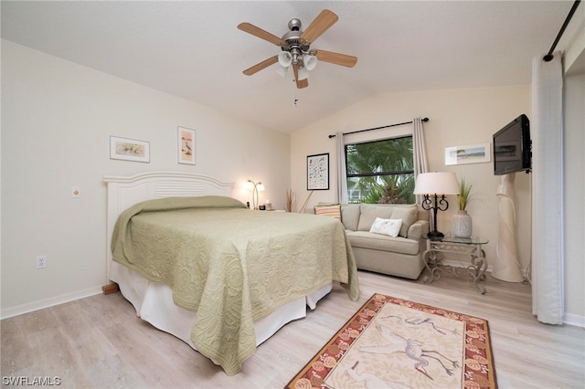 bedroom with ceiling fan, wood-type flooring, and lofted ceiling