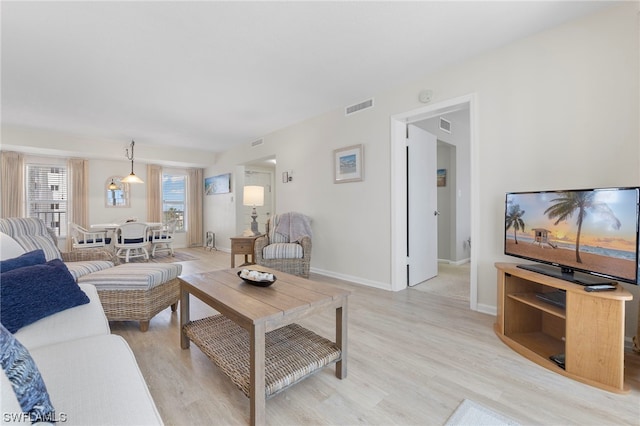 living room with light hardwood / wood-style flooring