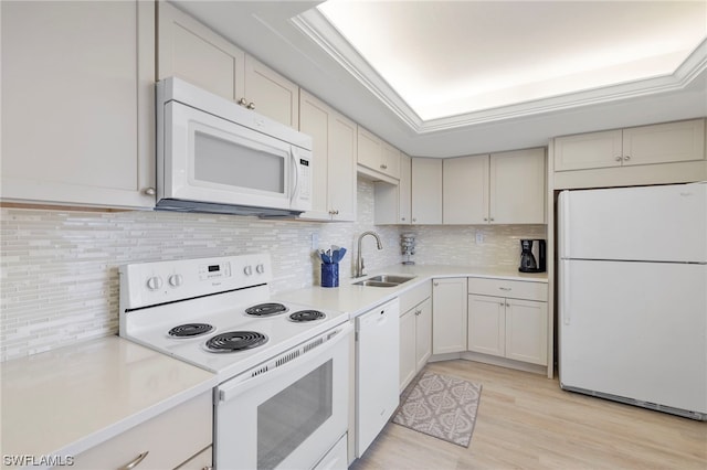 7000 Estero Blvd Unit 403, Fort Myers Beach, FL 33931 - kitchen featuring white appliances, a sink, light countertops, decorative backsplash, and light wood-type flooring