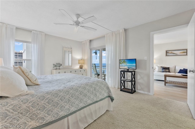 carpeted bedroom featuring access to exterior, ceiling fan, and multiple windows