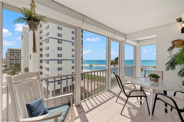 7000 Estero Blvd Unit 403, Fort Myers Beach, FL 33931 - sunroom featuring a water view and tile patterned flooring