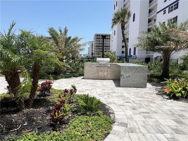 7000 Estero Blvd Unit 403, Fort Myers Beach, FL 33931 - surrounding community featuring an outdoor kitchen and a patio area
