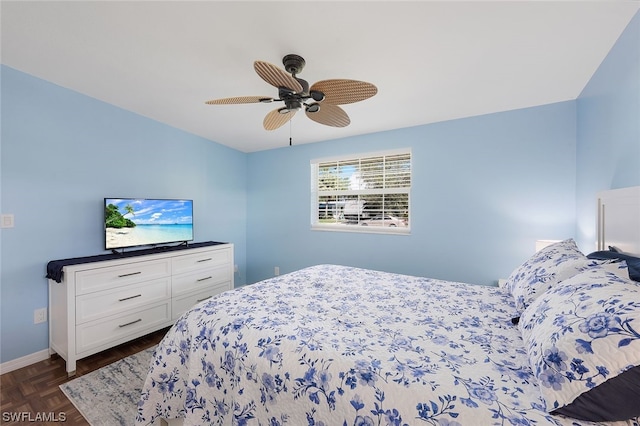 bedroom with ceiling fan and dark parquet floors