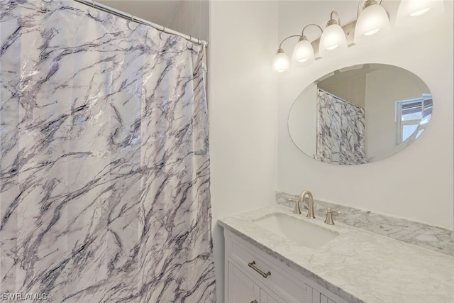 bathroom with a shower with shower curtain and vanity