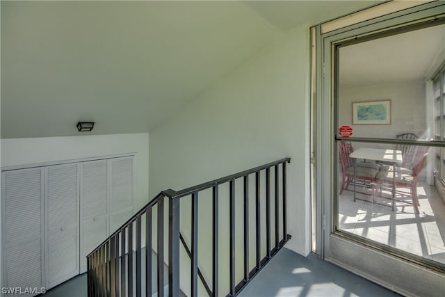 stairway with vaulted ceiling