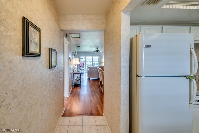 hallway featuring light tile floors