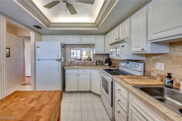 kitchen with white appliances, white cabinetry, backsplash, and ceiling fan