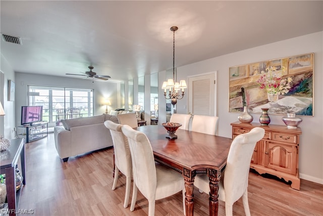 dining area featuring light hardwood / wood-style floors and ceiling fan with notable chandelier