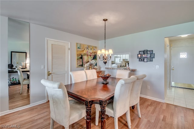 tiled dining space with a chandelier and a wealth of natural light