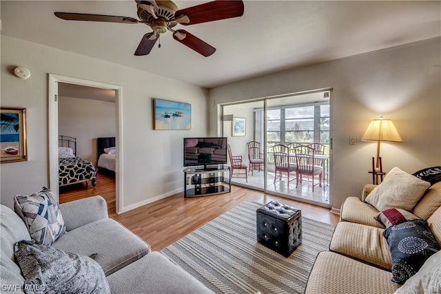 living room featuring light hardwood / wood-style flooring and ceiling fan