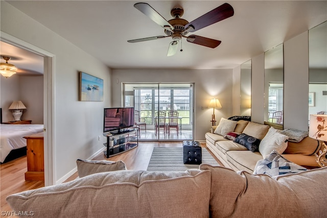 living room featuring plenty of natural light, ceiling fan, and light hardwood / wood-style flooring