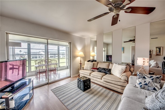 living room with ceiling fan and light wood-type flooring